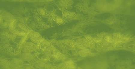 Blur of elegant green fabric featuring glowing, swirling floral motifs. The texture has a luminous appeal, adding sophistication to backgrounds or textile patterns.の写真素材