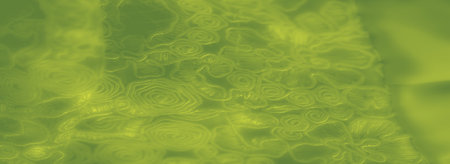 Blur emphasizes green fabric with embroidered swirls and loops, providing a textured, luxurious effect. The abstract, layered design creates a soft, artistic backgroundの写真素材