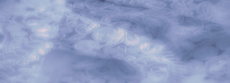 Blur of intricate lace fabric with light blue floral and spiral patterns. The gentle folds create a textured effect, giving the fabric a refined and luxurious appearance.の写真素材