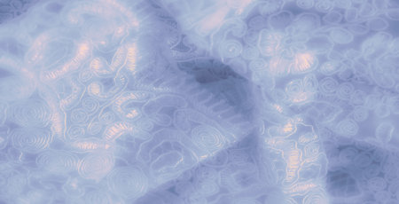 Blur of luxurious lace fabric with detailed light blue swirls and floral motifs. The soft folds and fine embroidery create a timeless, sophisticated feel to the textile.の写真素材