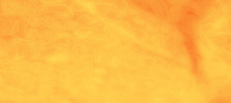 Blur. A yellow fabric with intricate, swirling floral patterns and gentle folds that flow throughout. The soft, warm tone creates an inviting texture, perfect for decorative useの写真素材