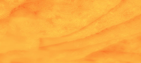 Blur. Yellow fabric with intricate swirls and floral shapes softly blending into each other, creating an elegant texture. Ideal for background use in design and artistic projects.の写真素材
