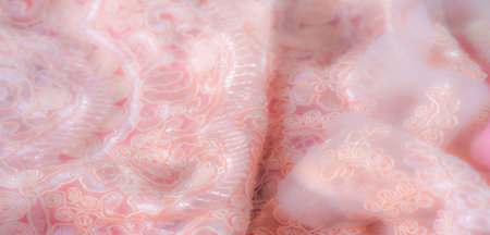 Blur, detailed embroidery with floral and swirl patterns covers this peach lace fabric. Soft and delicate, it's ideal for fashion, dÃ©cor, and intricate design projects.の写真素材