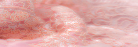 Blur, soft peach lace fabric with an elegant swirl and floral pattern, featuring a textured, delicate finish ideal for wedding fashion or sophisticated home decor.の写真素材