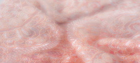 Blur, soft pink fabric with delicate lace designs and swirling, organic shapes that give the material a refined and elegant look, ideal for bridal or luxury decor.の写真素材