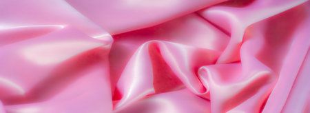 Blur. This silky pink fabric flows in soft, luxurious folds, adding a delicate touch to any design. The smooth texture and pastel hue create a calming, elegant effect.の写真素材