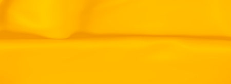 Blur of vibrant yellow fabric with gentle folds, creating a smooth and seamless texture. The vivid hue and soft material lend a lively yet calming effect, making it ideal for creative backgrounds,の写真素材