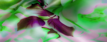 Blur of green and pink-toned fabric with a mix of purple floral elements and graceful folds, creating an impression of softness and beauty in a harmonious color blendの写真素材