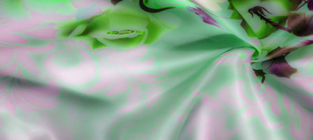 Blur of pastel green and purple floral patterns drifting across soft fabric, with an elegant interplay of folds and a delicate nature-inspired abstract design.の写真素材