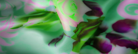Blur of smooth floral patterns in soft green, pink, and purple tones, flowing gracefully across the fabric, adding a dreamy, ethereal vibe with gentle folds.の写真素材