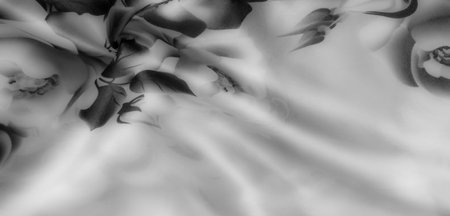 Blur of intricately folded satin-like fabric, featuring subtle floral patterns and an elegant black and white color scheme, which accentuates its luxurious appeal.の写真素材