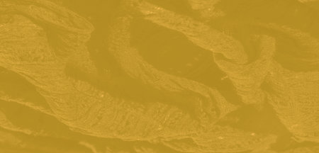 Blur, this close-up of yellow fabric displays a rich texture with gentle patterns and light...
