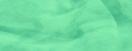 Blur. Delicate green fabric with soft floral and chain designs, elegantly folded to create subtle textures and a dreamy, translucent look that enhances its graceful appearance.の写真素材