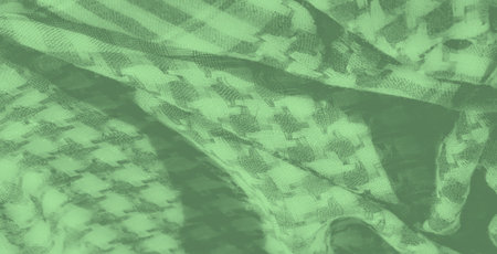 Blur. Close-up of a green fabric with a subtle checkered weave. The folds create a dynamic texture, blending shades and lines for a refined and cozy visual effect.の写真素材