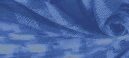 Blurred abstract fabric in blue with a subtle, textured grid pattern, featuring soft folds and intricate shading that brings depth and sophistication to the textile design.の写真素材