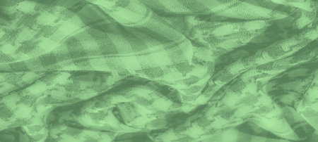 Blur the interwoven pattern and soft hues of green on this fabric create an engaging, textured effect, perfect for backgrounds, textiles, or layered design elements.の写真素材
