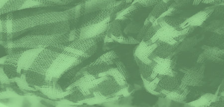 Blur of a smooth green fabric with a subtle stripe and cross-weave pattern, offering a sophisticated texture ideal for background use in design projectsの写真素材