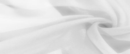 Blurred soft white fabric with flowing folds and a smooth texture, creating a calm and airy appearance perfect for minimalist backgrounds and creative designsの写真素材