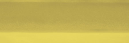 Blur of yellow fabric with elegant folds and a soft flow, creating a serene atmosphere. The smooth...