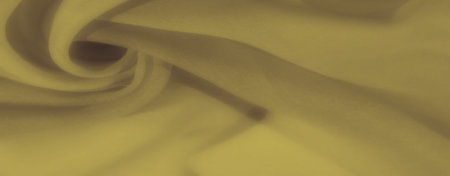 Blur of yellow fabric in soft, flowing folds that create a warm, inviting texture, perfect for...