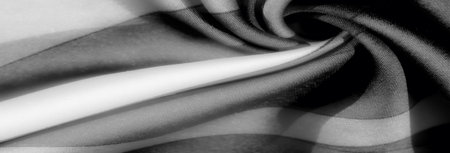 Blur: A mesmerizing blend of black, white, and gray tones flows across this folded fabric, creating a gentle rhythm of light and shadow. The soft texture adds depth and dimension.の写真素材