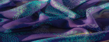 Blur A beautifully detailed purple fabric with turquoise highlights, artistically folded to reveal...