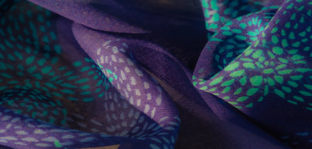 Blur A beautifully detailed purple fabric with turquoise highlights, artistically folded to reveal texture and elegance. The harmonious blend of colors enhances the fabric's sophisticatedの写真素材