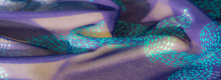 Blur A richly colored purple fabric with intricate turquoise patterns, draped in soft folds that...