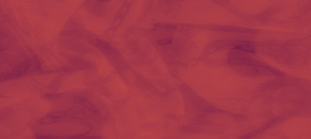 Blurred soft red fabric with intricate floral motifs entwined with chain patterns, offering a subtle yet detailed texture that adds depth to the fabric's appearance.の写真素材