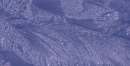 Blur effect brings out the soft, flowing texture of a light lavender fabric, creating an elegant and...