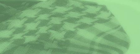 Blur of green fabric with soft plaid and houndstooth patterns. The layered folds and shadows give an...