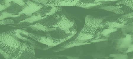 Blur of soft green textile with woven stripes and intricate checks. This fabric's textured pattern and natural folds add an aesthetic appeal, suitable for backgrounds in digital or print designsの写真素材