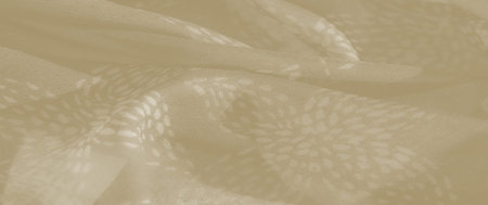 Blurred folds of beige fabric create a soft, flowing texture, accented by subtle floral patterns...