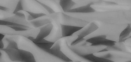 Blurred view of softly draped grayscale fabric with light and shadow interplay, offering a minimalist and timeless aesthetic perfect for versatile applications.の写真素材