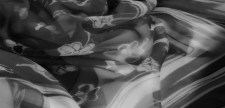 Blur a soft, flowing grayscale fabric with intricate floral motifs and subtle shading, creating a harmonious blend of art and design for modern elegance and style.の写真素材