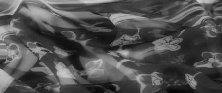 Blur. Fabric in grayscale with delicate flower patterns that flow gracefully. The smooth texture and subtle folds create a modern and sophisticated look.の写真素材