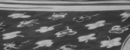 Blurred grayscale image showing delicate floral patterns on translucent fabric. The folds and textures create a soft, elegant interplay of light and shadow.の写真素材