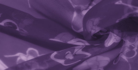 Blur delicate purple fabric featuring artistic floral and striped patterns, perfectly blending sophistication and elegance with its soft texture and layered folds.の写真素材