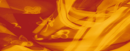 Blur: Abstract orange fabric with floral patterns, showing intricate layers and shadows for a bold and dynamic visual appeal. Perfect for creative and artistic projects.の写真素材
