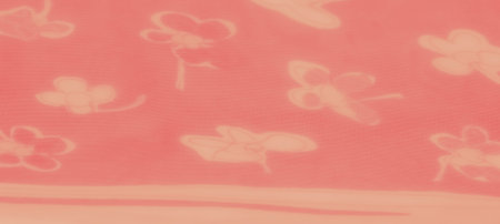 A vivid orange fabric featuring abstract floral patterns with soft folds and transparent layers,...