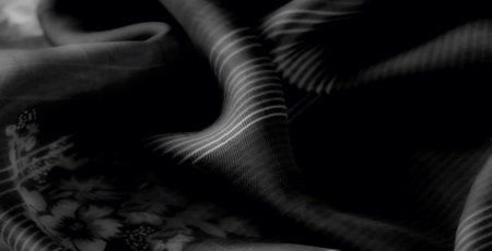 Blur the striking folds of black fabric with a harmonious mix of soft floral patterns and bold...
