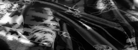 Blur: A patterned fabric in grayscale featuring geometric shapes and chains, blending traditional and modern styles with a bold, striking texture and reflective highlights.の写真素材