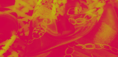 Blur. A vibrant yellow and red fabric displaying intricate floral and geometric patterns intertwined...