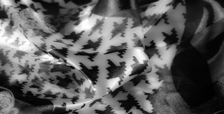 Blur - Glossy grayscale fabric with bold geometric and floral patterns enhanced by shiny textures...