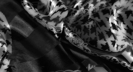 Blur - Intricately designed fabric with a grayscale chain motif and bold houndstooth pattern, featuring a glossy texture and soft folds for added depth.の写真素材