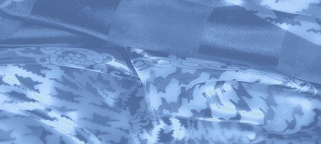 Blur: Elegant textile design with blue hues featuring geometric and chain details. Gentle folds and soft lighting give it a luxurious and sophisticated appearance.の写真素材