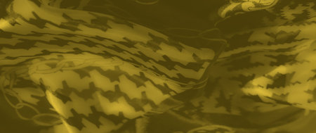 Blurred closeup of yellow fabric with alternating zigzag and chain patterns. The high contrast...