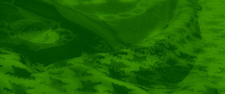 Blur - A green fabric enriched with houndstooth and chain-like motifs, displayed in soft, flowing layers. The artistic design highlights its elegance and modern sophistication.の写真素材