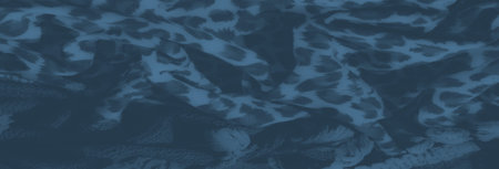 Blurred fabric with a dynamic leopard pattern combined with braided elements, emphasizing the interplay between smooth textures and rough woven details.の写真素材