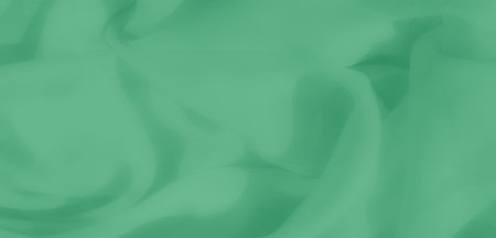 Blur of a vibrant green fabric draped in smooth, fluid folds, offering a contemporary aesthetic with...
